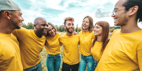 Multi ethnic young people team hugging together outside - International community of students support and help each other - Friendship, team building and diversity concept