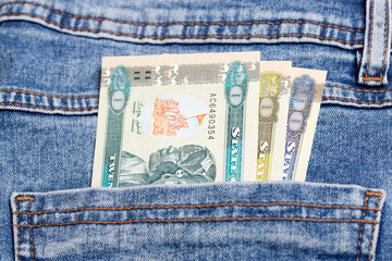 Eritrean Nakfa in the pocket of blue jeans