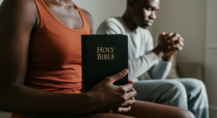 Faithful Devotion: Black Christian Couple Praying on Their Knees in a Bright Room
