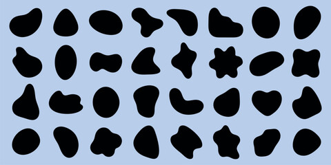 Fototapeta premium Abstract black shapes on a light blue background. Various organic shapes, abstract and irregular. Black shapes contrast with blue. Abstract art, organic forms. Black shape vector set.