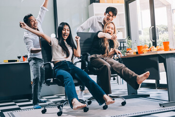 Fototapeta premium Asian office colleagues and friends enjoy a daytime BBQ with pizza and beer, celebrating Halloween and cheering for their favorite soccer team, creating a lively atmosphere filled with joy.