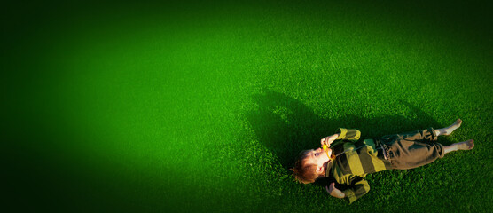 The child goes in for sports at the stadium. The boy training before playing football. banner with...