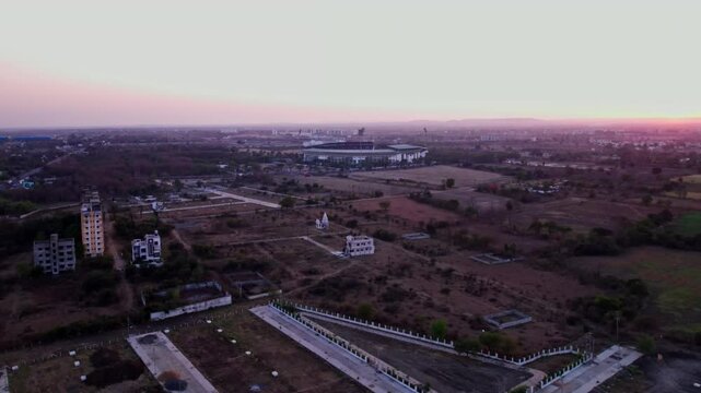 agricultural land with VCA Stadium and sky at jamtha village, nagpur, maharashtra, india. sun set time, push in, drone shot, 4k.