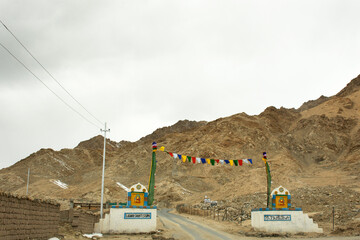 Gate for tibetan people and foreigner travelers entrance to Shanti Stupa on a hilltop in Chanspa...