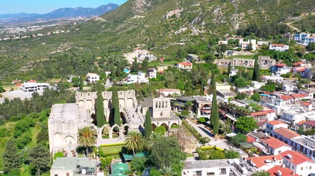 Aerial view of Bellapais Abbey, a historical monastery located in northern Cyprus, showcasing its stunning architecture and the charming village surrounding it. Kyrenia District, Cyprus