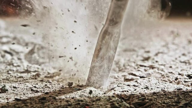 SLO MO Chisel of a jackhammer penetrating concrete