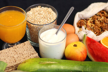 Various healthy fruits, vegetables and cereals on dark background. Selective focus.