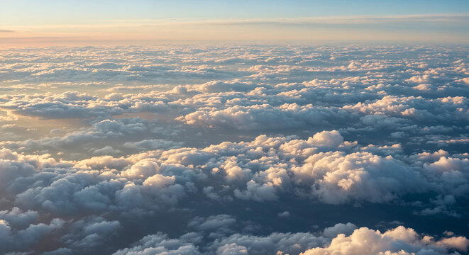 Aerial view of fluffy clouds at sunset, ethereal cloudscape from above with golden sunlight, dreamy atmosphere for nature and travel concepts, peaceful sky background