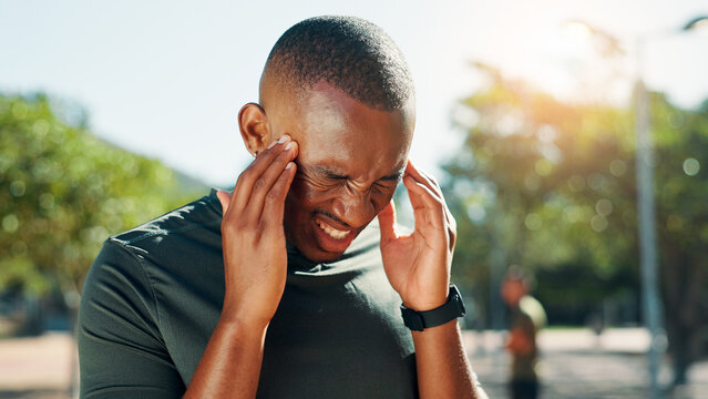 Fitness, headache and man with pain, stress and African person exhausted with intense training outdoor. Migraine, exercise and sick sports athlete with fatigue, tired or dehydration with heat at park