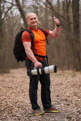 Fototapeta premium Photographer giving thumbs-up in the forest........