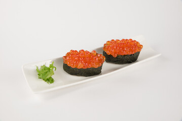 Traditional Japanese Ikura Gunkan Maki Sushi with Salmon Roe on a White Plate
