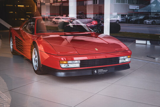 09-03-2025 Urdorf, Canton Zurich, Switzerland. Red Ferrari 512 TR or testarossa inside dealer showroom floor. Outside-looking-in shot, no people