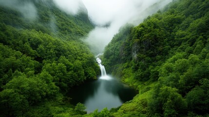 A breathtaking view of a waterfall cascading into a serene lake, embraced by vibrant greenery and mist, creating a tranquil natural oasis.