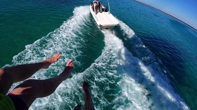 Above the vibrant blue waters of Egypt while parasailing, taking in stunning views of the coastline and enjoying the thrill of this exciting water activity. A perfect mix of adventure and beauty.