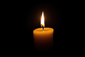 Single candle flame against dark background (2)