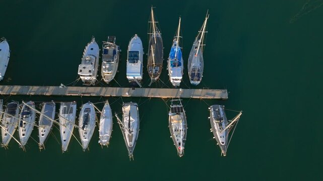 Top-Down View of Sailboats and Yachts Moored at Wooden Dock in Marina