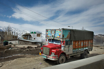 Traffic road with Indian and tibetan people drive car and colorful truck on Srinagar Leh Ladakh highway at Leh Ladakh in Jammu and Kashmir, India