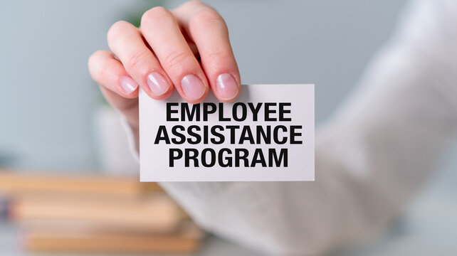 A person is holding a white card that says Employee Assistance Program