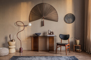 Minimalist console table with artistic decor and a statement fan wall piece in warm natural tones.