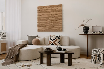 Minimalist coffee table styling with a black teapot, nuts, and textured ceramics. A warm and inviting setting for a cozy home...