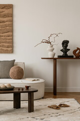 Bright and airy living space with soft furnishings, natural wood, and abstract artwork. A serene...