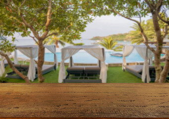 Wooden table top on the beach or sea. swimming pool Party on the beach  sunshine time concept.For montage product display or design key visual layout.View of copy space.