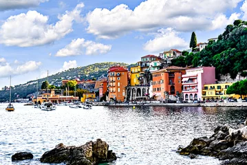 Image of the picturesque village and beach of Villefranche-sur-Mer, France with tourists in August, with its colorful houses.