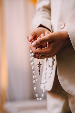 Boy Holding Rosary Beads on First Holy Communion Day