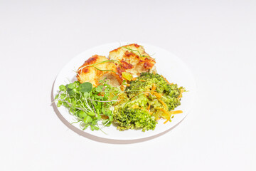 A stylishly plated gourmet fish dish with golden-brown fillet, fresh microgreens, and colorful vegetables.
