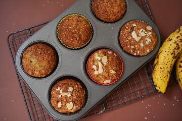 Homemade Banana muffins topped with nuts, selective focus