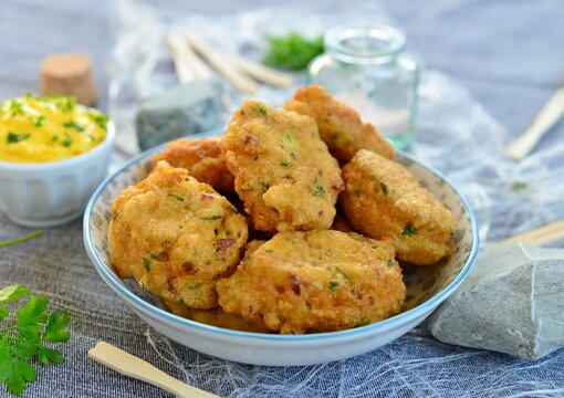 Close-up of a bowl of Salt cod fritters with aioli on a table