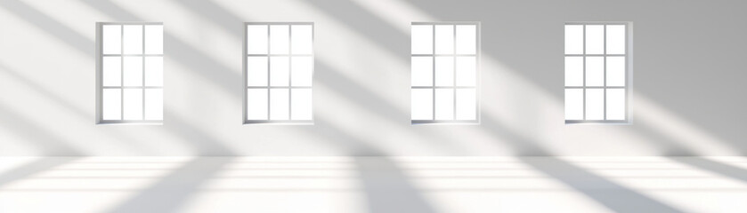 Bright and airy room with four windows casting shadows on floor, creating serene atmosphere