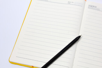 black ballpoint pen on open book ready to write down work plan