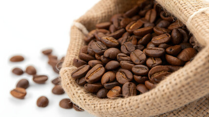 Fototapeta premium Dark roasted coffee beans, a brown heap of aromatic grain in a burlap sack