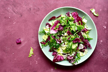 Mix of fresh salad leaves on a plate. Top view with copy space.