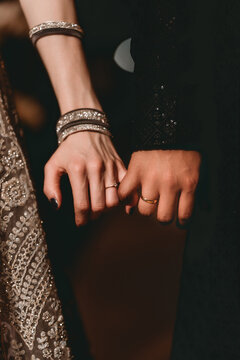Close-ups details or poses of engaged couple's hands with ring