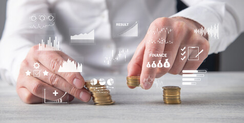 Stack of coins with a financial growth graphs.