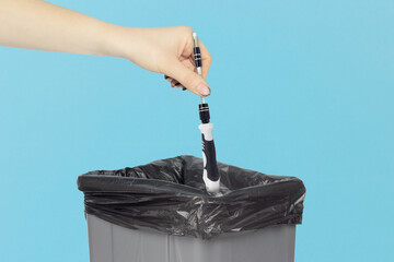 throw screwdriver with replaceable tip for electronics repair into trash can, screwdriver in hand in front of trash can