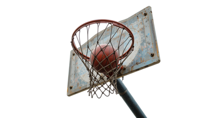 Weathered outdoor basketball hoop with a ball suspended in motion