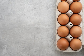 Chicken eggs lie in a tray on a light background. Fresh egg on morning breakfast. Concept farm products and natural nutrition
