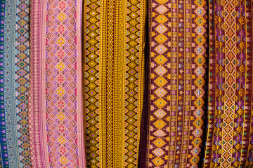 Material silk fabric and raw hand woven cotton with ancient pattern and antique design texture for show and sale in handmade crafts market fair and studio workshop at Bitec Bangna in Bangkok, Thailand