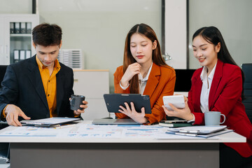 Businessmen team or financial data analysts working with tablets and laptop computers and data graphs together.