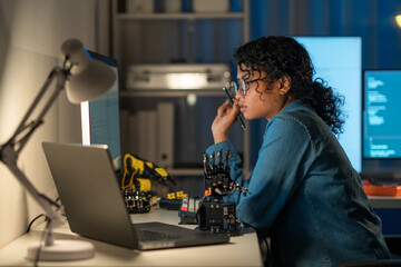 Experience the evolution of programming through the lens of an Asian woman in tech at night.