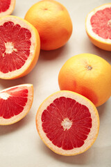 Fresh raw grapefruit on light background. Vertical photo