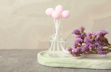 Air freshener on grey. White aroma diffuser bottle with sticks. Minimalism. Top view