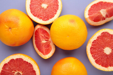 Fresh raw grapefruit on a purple background