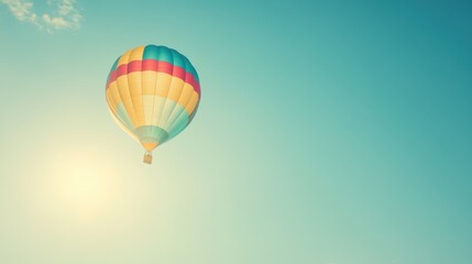 Naklejka premium Colorful hot air balloon soaring in a clear blue sky. (1)