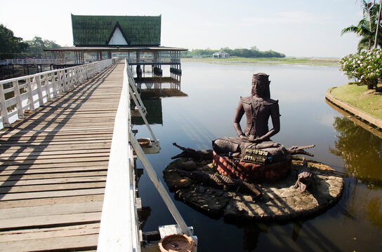Crocodile statue name Chalawan at front of pavilion in lake for people resting and visit at Bueng Si Fai public park