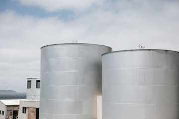Two large, cylindrical storage tanks with a flat top.