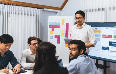 Project manager communicate and collaborate with team using project management software display on...